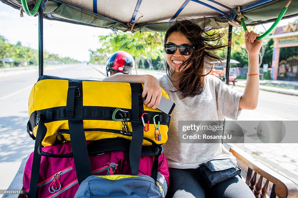 Woman riding in auto rickshaw, Siem Reap, Cambodia