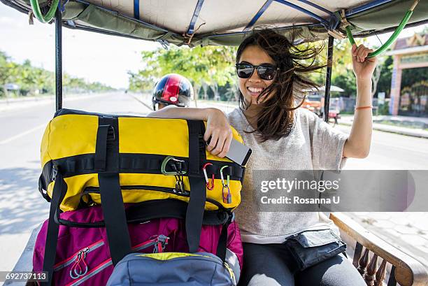 woman riding in auto rickshaw, siem reap, cambodia - rickshaw fotografías e imágenes de stock