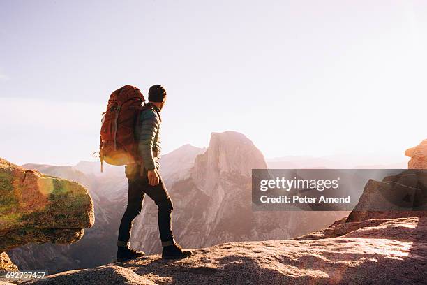 hiker walking on mountain path, yosemite, california, usa - hiking backpack stock pictures, royalty-free photos & images