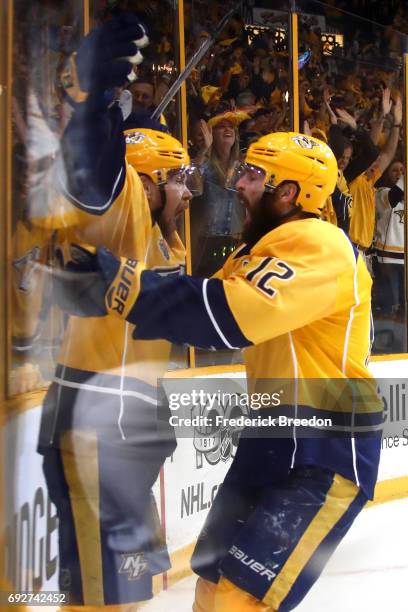 Viktor Arvidsson of the Nashville Predators celebrates with teammate Mike Fisher after scoring a goal on Matt Murray of the Pittsburgh Penguins...