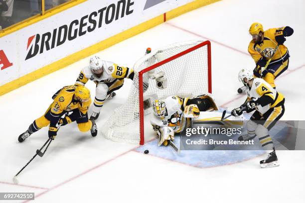 Matt Murray of the Pittsburgh Penguins tends to net against Frederick Gaudreau and P.A. Parenteau of the Nashville Predators as Ian Cole and Justin...