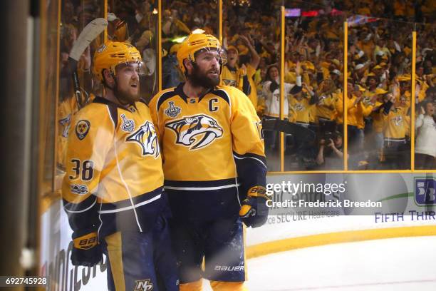 Viktor Arvidsson of the Nashville Predators celebrates with teammate Mike Fisher after scoring a goal on Matt Murray of the Pittsburgh Penguins...