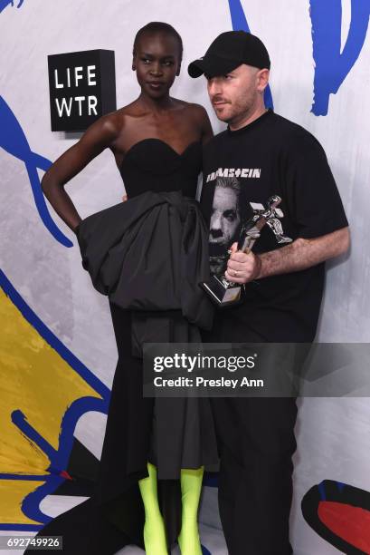 Model Alek Wek and designer Demna Gvasalia for Vetements and Balenciaga poses with International Award on the Winners Walk during 2017 CFDA Fashion...