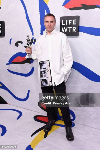 Designer Raf Simons for Calvin Klein poses with Womenswear Designer of the Year award on the Winners Walk during 2017 CFDA Fashion Awards at...