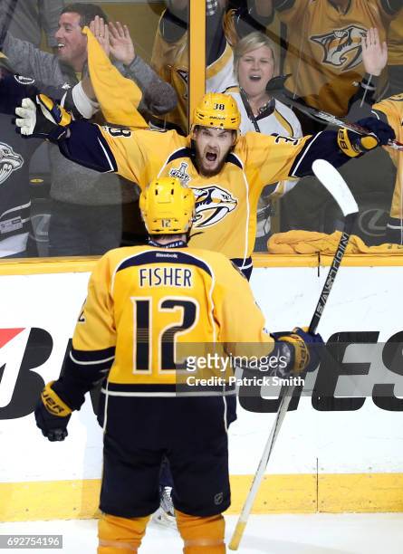 Viktor Arvidsson of the Nashville Predators celebrates with teammate Mike Fisher after scoring a goal on Matt Murray of the Pittsburgh Penguins...