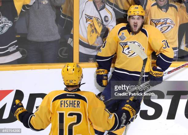 Viktor Arvidsson of the Nashville Predators celebrates with teammate Mike Fisher after scoring a goal on Matt Murray of the Pittsburgh Penguins...