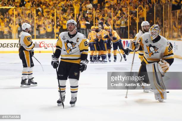 Phil Kessel, Sidney Crosby and Matt Murray of the Pittsburgh Penguins react as Filip Forsberg of the Nashville Predators celebrates with his...