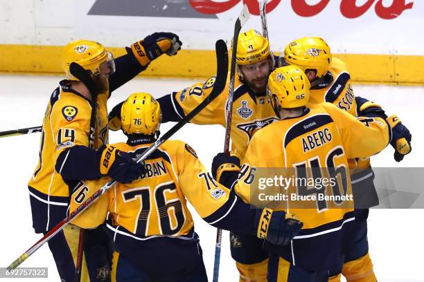 Filip Forsberg of the Nashville Predators celebrates with his teammates after scoring an open net goal against the Pittsburgh Penguins during the...