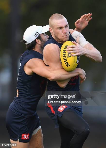Tom McDonald of the Demons is tackled by Jordan Lewis during a Melbourne Demons AFL training session at Gosch's Paddock on June 6, 2017 in Melbourne,...