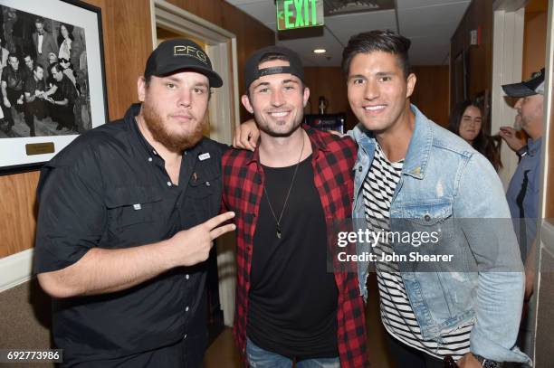 Musicians Luke Combs, Michael Ray and Dan Smyers of Dan + Shay take photos backstage during the 8th annual Darius & Friends concert to benefit St....