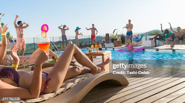 group of friends having pool party - rooftop pool imagens e fotografias de stock
