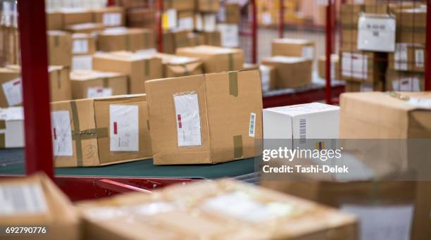 cardboard boxes package on conveyor belt - parcel sorting stock pictures, royalty-free photos & images