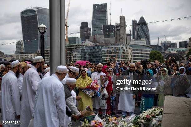 Members of the Muslim community lay flowers after attending a vigil for the victims of the London Bridge terror attacks, in Potters Fields Park on...