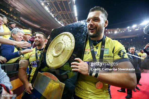 Damien Chouly and Raphael Chaume of ASM Clermont Auvergne show the Bouclier de Brennus trophy to the fans after winning the Top 14 final match...