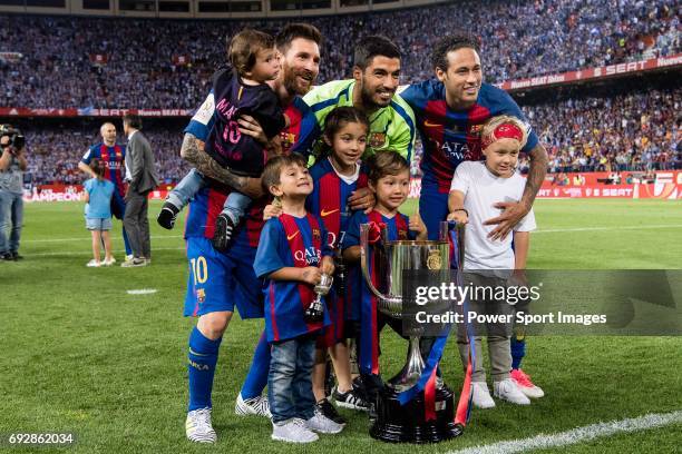 Lionel Messi, Luis Suarez, Neymar da Silva Santos Junior of FC Barcelona and their sons poses with the trophy after won the Copa Del Rey Final...