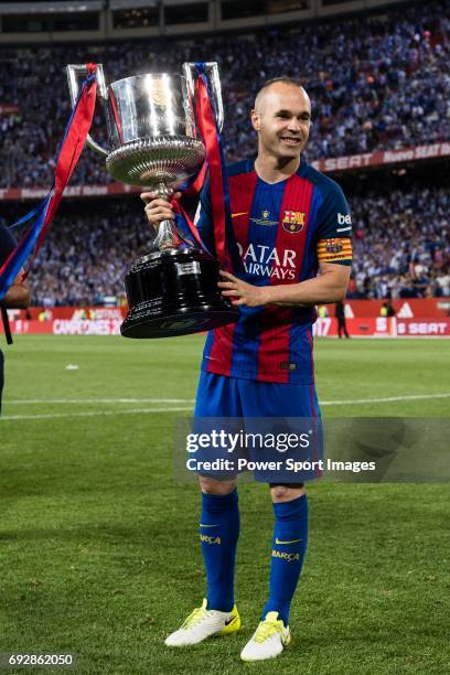 Andres Iniesta Lujan of FC Barcelona poses for photos with the winner trophy for the Copa Del Rey Final between FC Barcelona and Deportivo Alaves at...