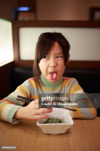 little girl making a face in lunch. - eye roll stock pictures, royalty-free photos & images