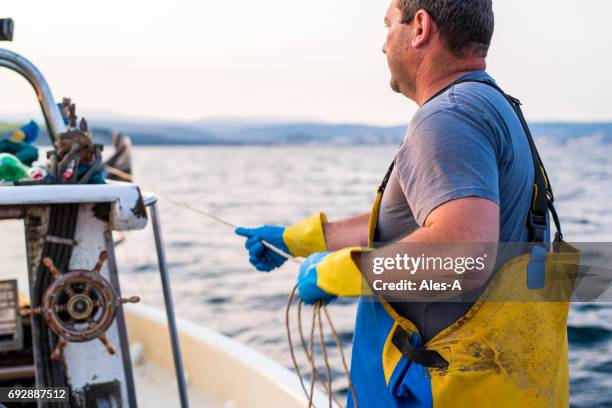 fisherman at work - fishing boat net stock pictures, royalty-free photos & images