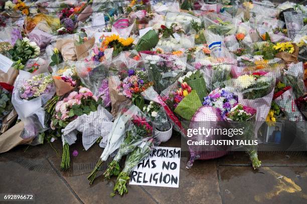 Flowers are pictured at the south-side of London Bridge in London on June 6 placed in memory of the victims of the June 3 terror attacks. Police on...