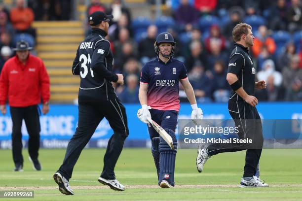 Eoin Morgan of England walks after being caught behind by Luke Ronchi off the bowling of Corey Anderson of New Zealand during the ICC Champions...