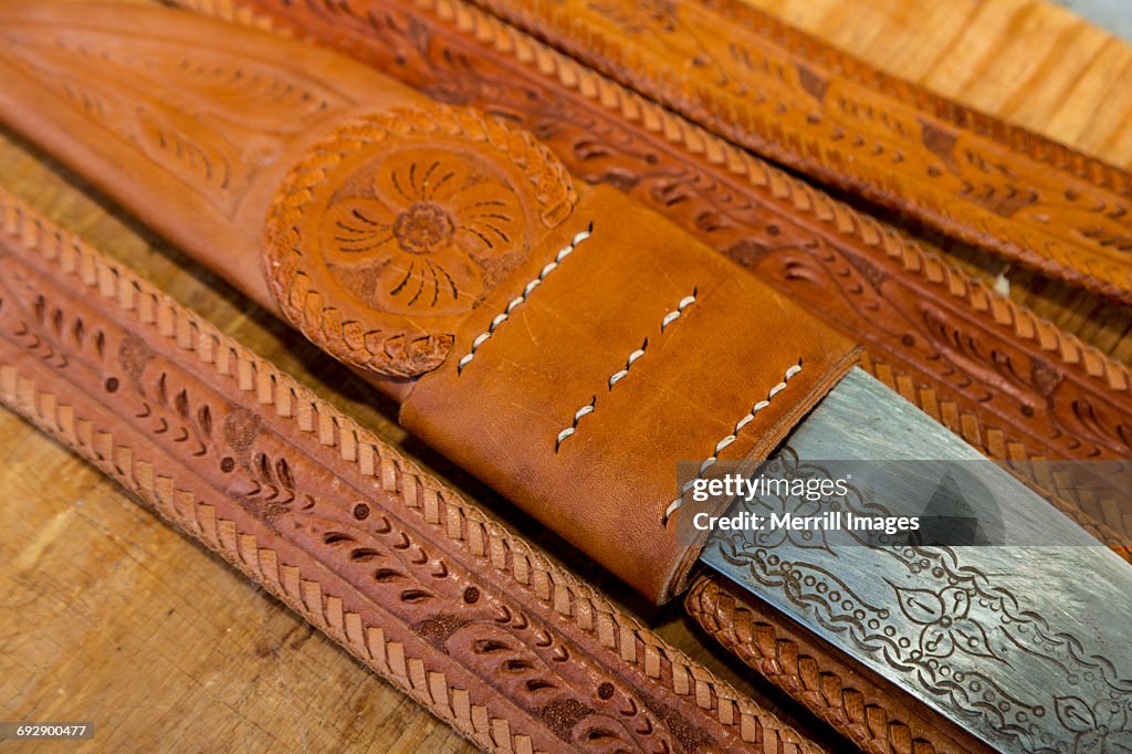 Hand-tooled leather belt with knife holder