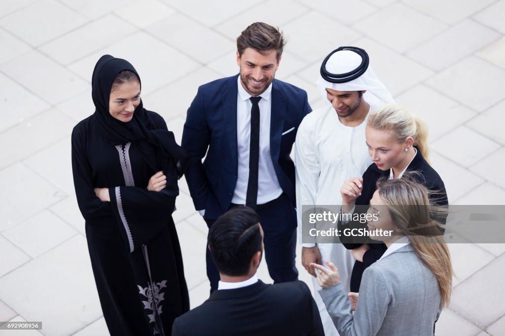 Colleagues outside of their office having a conversation