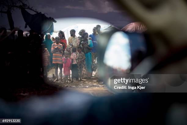 Baidoa, Somalia Hilac refugee camp. A group of refugees is reflected in the rear mirror of a car on May 01, 2017 in Baidoa, Somalia.