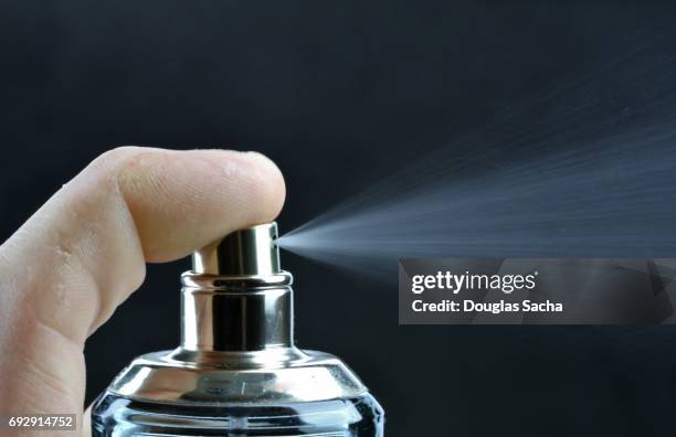 spray of scented cologne from a perfume bottle - spray bottle stock pictures, royalty-free photos & images