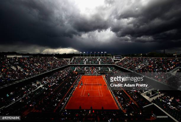 General view inside Court Philippe Chatrier as coulds begin to form during the ladies singles Quarter Finals match between Kristina Mladenovic of...