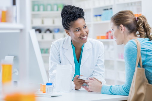 Pharmacy customer asks pharmacist question about medication