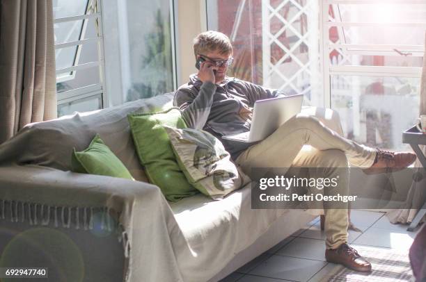 sunny days on the couch. - tall skinny blonde stock-fotos und bilder