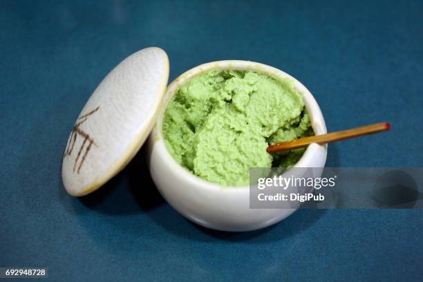 finely grated wasabi served in porcelain container on table - wasabi stock pictures, royalty-free photos & images