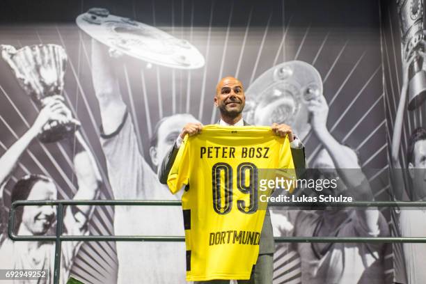 Peter Bosz, the new head coach of Borussia Dortmund, poses with a jersey of Dortmund after a press conference at Signal Iduna Park on June 6, 2017 in...