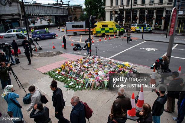Flowers are pictured at the south-side of London Bridge, opposite the Barrowboy and Banker pub, and close the Borough Market in London on June 6...