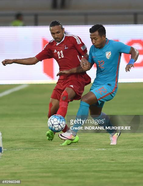 Nepal's Rohit Chand tackles India's Jeje Lalpekhlua during an international football friendly match between India and Nepal in Mumbai on June 6,...