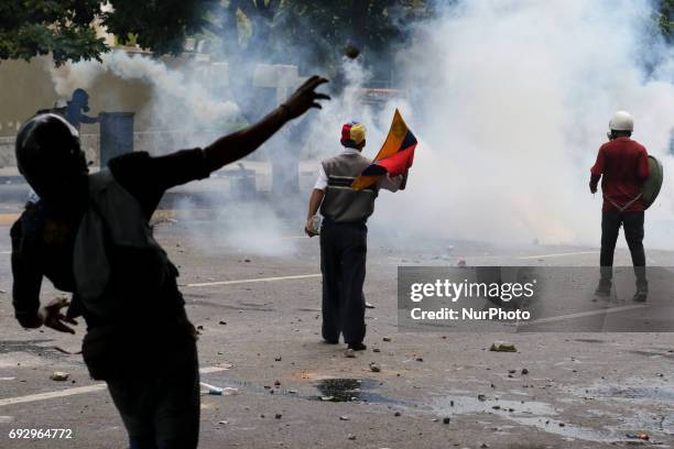 Opposition activists clash with riot police during a demonstration against the government of President Nicolas Maduro in Caracas, on June 5, 2017....