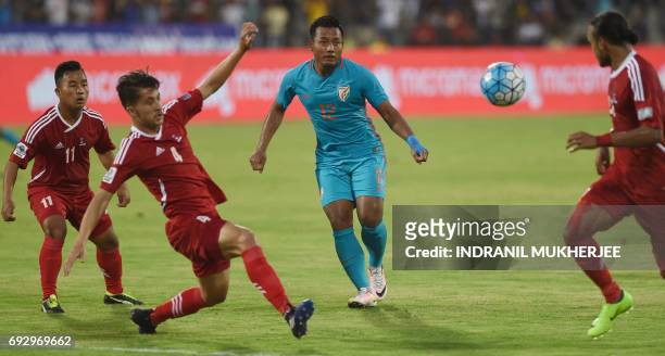 India's Jeje Lalpekhlua shoots past Nepal's Heman Gurung , Ananta Tamang and Rohit Chand during an international football friendly match between...
