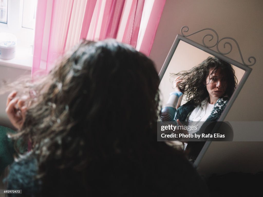 Woman using hairdryer