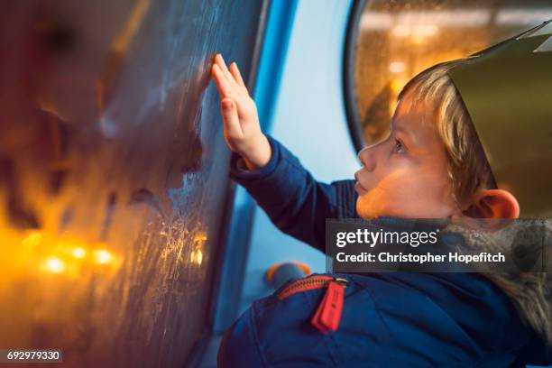 young boy on a bus at night - condensation drawing stock pictures, royalty-free photos & images