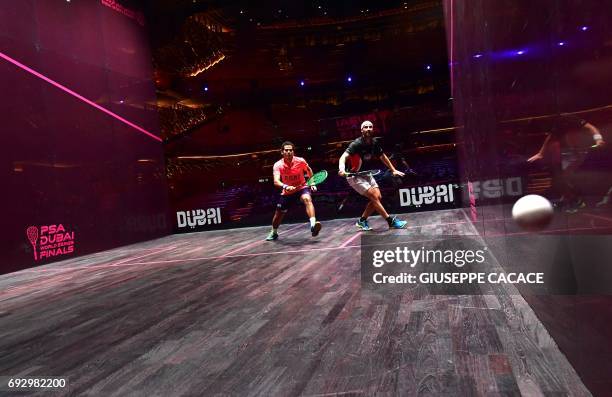 Karim Abdel Gawad of Egypt competes against Simon Rosner of Germany during the first day of the PSA Dubai World Series Finals 2017 at Dubai Opera on...