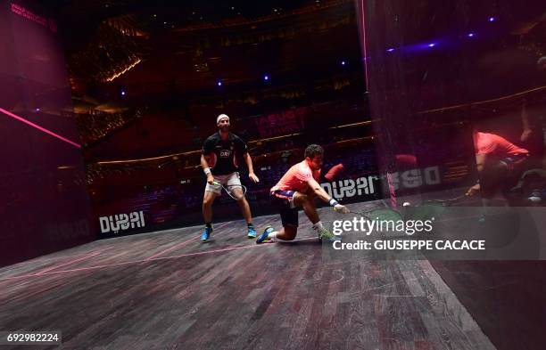 Karim Abdel Gawad of Egypt competes against Simon Rosner of Germany during the first day of the PSA Dubai World Series Finals 2017 at Dubai Opera on...