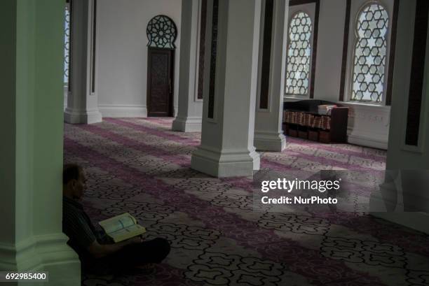 Muslim man recite the Holy Quran in a Jamek mosque during the Holy month of ramadan at Malaysia , Ramadan the Holiest month on Islamic calendar ,...