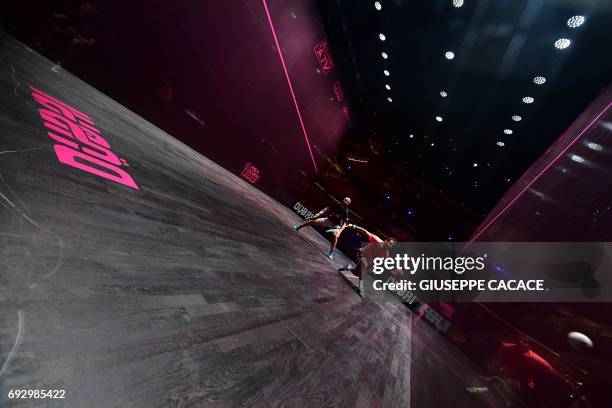 Karim Abdel Gawad of Egypt competes against Simon Rosner of Germany during the first day of the PSA Dubai World Series Finals 2017 at Dubai Opera on...