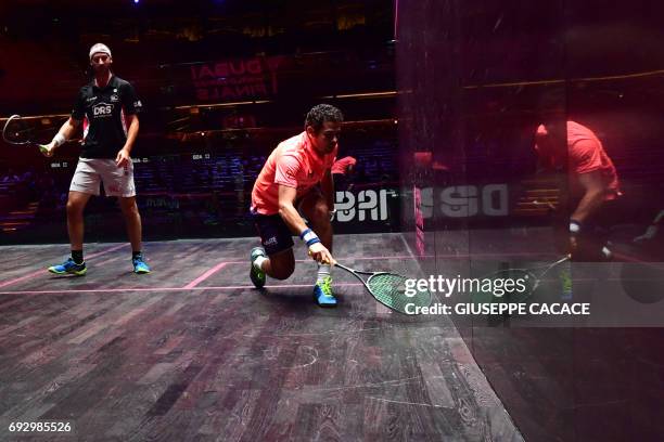 Karim Abdel Gawad of Egypt competes against Simon Rosner of Germany during the first day of the PSA Dubai World Series Finals 2017 at Dubai Opera on...