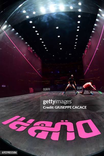 Karim Abdel Gawad of Egypt competes against Simon Rosner of Germany during the first day of the PSA Dubai World Series Finals 2017 at Dubai Opera on...