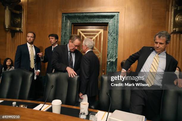 Sen. Bob Corker , talks with Chairman Mike Crapo , as Sen. Sherrod Brown , takes his seat during a Senate Banking, Housing and Urban Affairs...