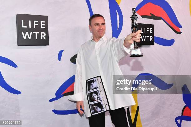 Menswear Designer of the Year Winner and Womenswear Designer of the Year Winner Raf Simons for Calvin Klein poses on the LIFEWTR Winner's Walk at the...