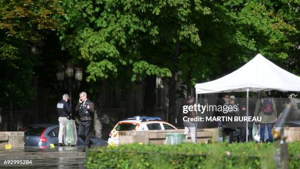 French police officials gather at the site of an attack near the entrance of Notre-Dame cathedral in Paris on June 6, 2017. Anti-terrorist...