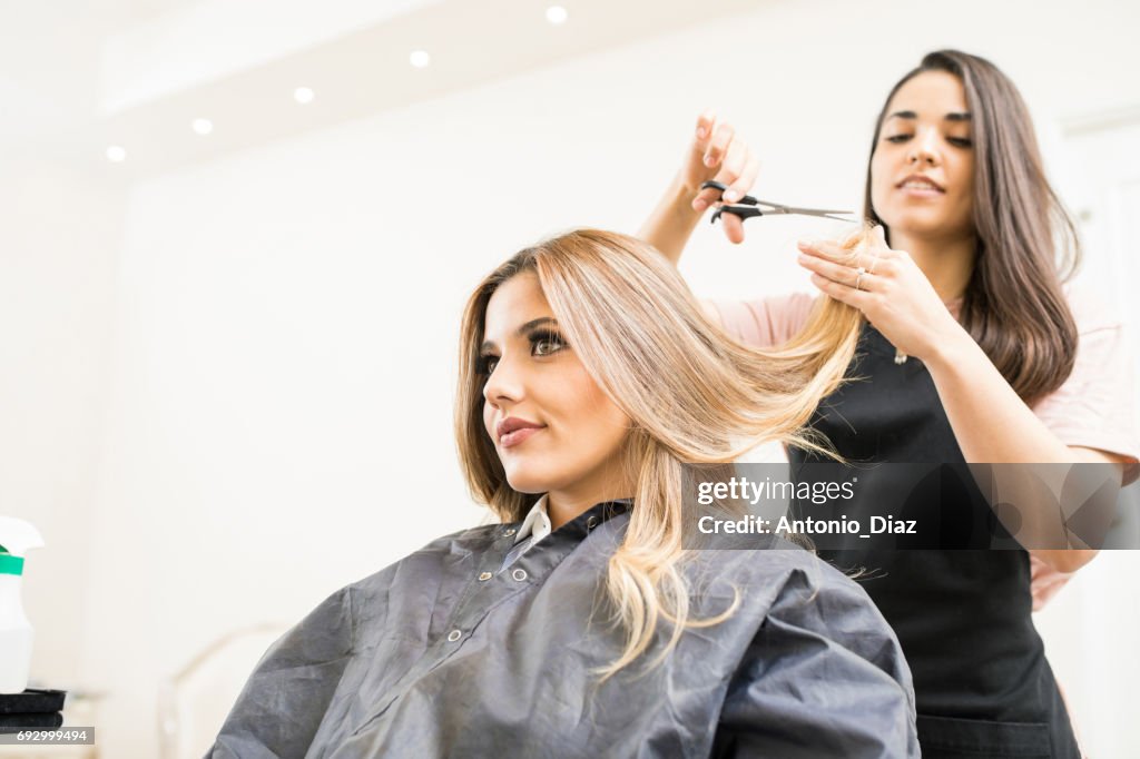 Hairdresser cutting some hair tips