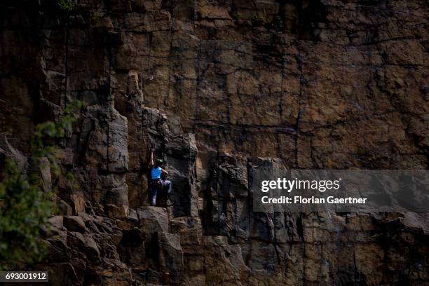 Woman climbs on the wall of a stone quarry on June 05, 2017 in Koenigshain, Germany.